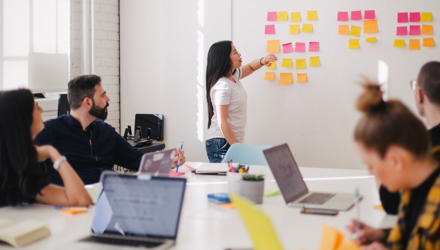 A meeting in an office space with a team brainstorming